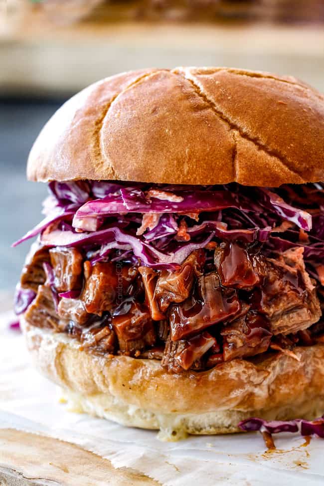 up close of brisket sandwich with barbecue beef brisket and coleslaw