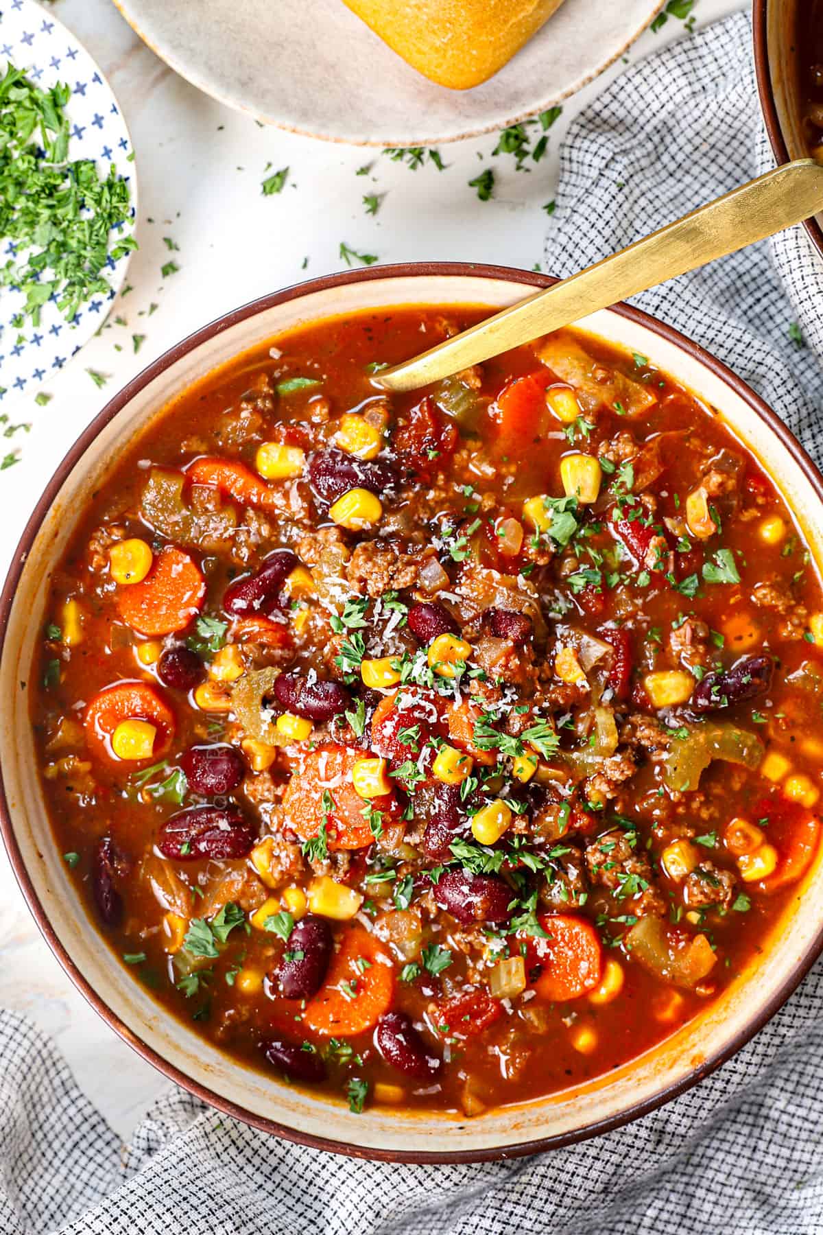 top view of a bowl of homemade vegetable beef soup showing how to serve with crusty bread