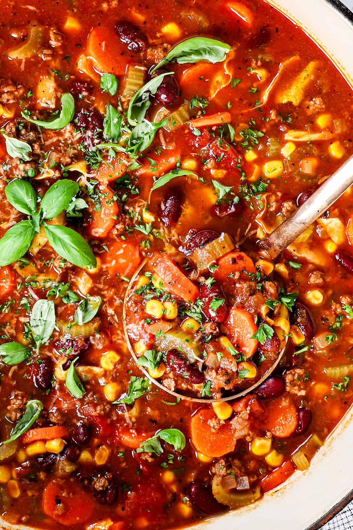 up close top view of Italian soup with a ladle showing the consistency of the soup