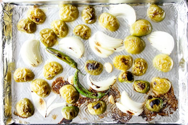 top view of roasted tomatillos, onions, jalapenos and garlic for roasted salsa verde recipe