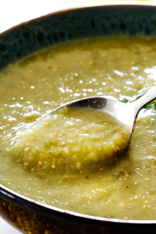 dipping a spoon into salsa verde to show consistency