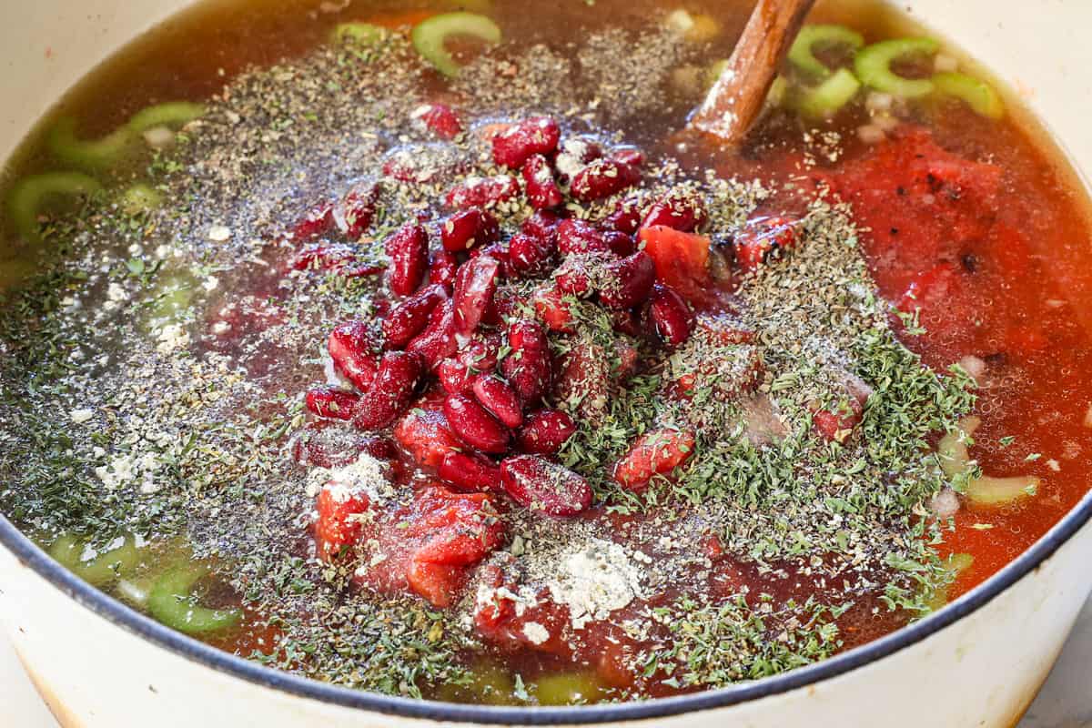 showing how to make vegetable beef soup recipe by adding the carrots, celery, kidney beans, diced tomatoes, Italian spices, beef broth