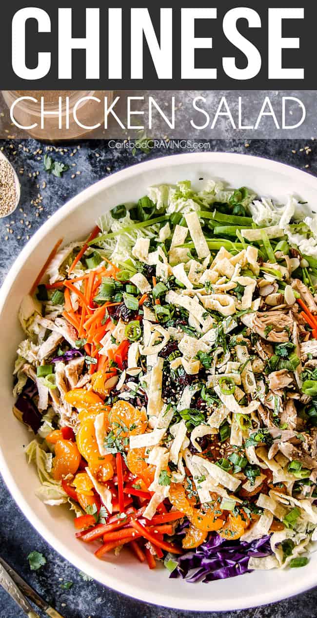 up close top view of crunchy chinese chicken salad with mandarin oranges, napa cabbage, wontons, carrots, snow peas, red bell peppers and sesame ginger dressing