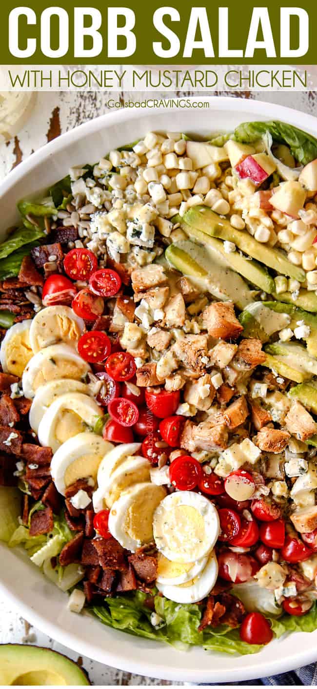 top view of Cobb salad with lettuce, hard boiled eggs, avocados, bacon, tomatoes and blue cheese