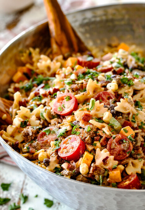 best Cowboy Pasta Salad with ground beef, black beans, corn, tomatoes and barbecue sauce in a metal bowl