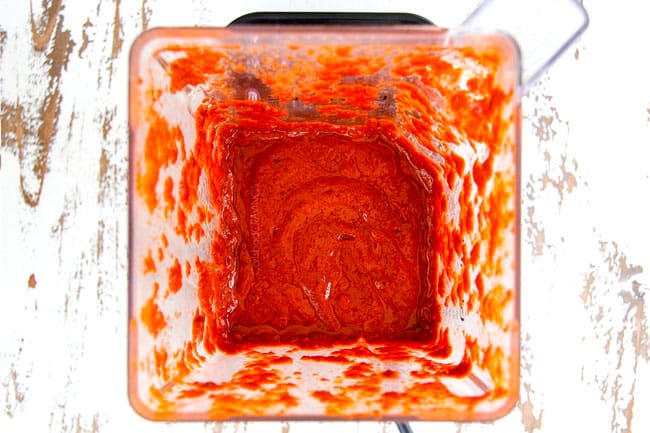 showing how to make al pastor with blended marinade that is bright red