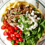 top view showing how to make caprese pasta salad with balsamic chicken, spinach tomatoes mozzarella
