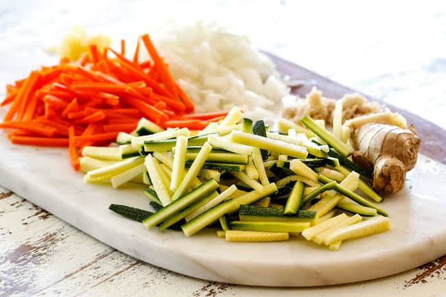 showing how to make Bang Bang Shrimp Copycat by cutting zucchini, carrots and onions