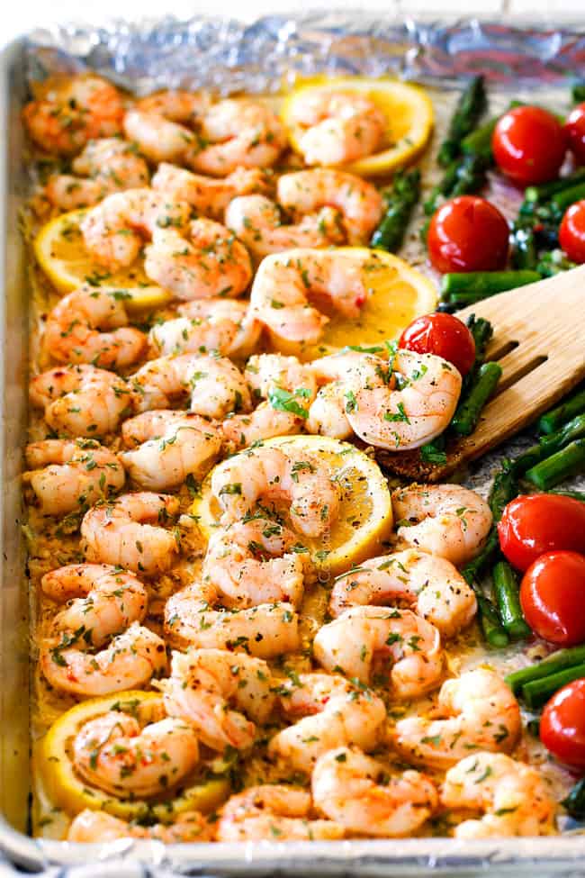 side view of baked shrimp scampi with tomatoes and asparagus