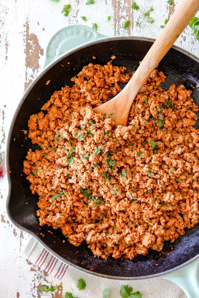 showing how to make turkey tacos by making ground turkey in a skillet with taco seasonings
