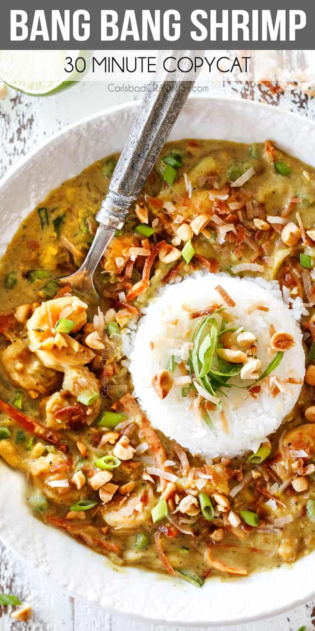 up close top view of Bang Bang Shrimp Copycat in a white bowl with a pile of rice in the center with coconut chili sauce