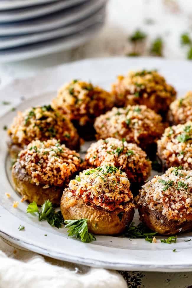 side view of best sausage stuffed mushrooms on a white serving plate
