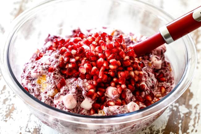 showing how to make ambrosia salad topping with pomegranate seeds