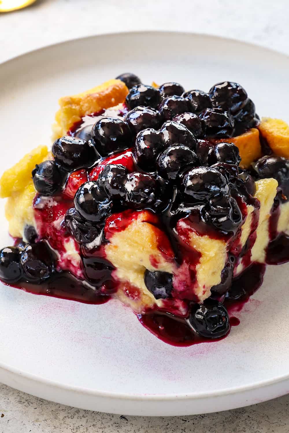 showing how to serve blueberry syrup (or sauce) by pouring over French toast