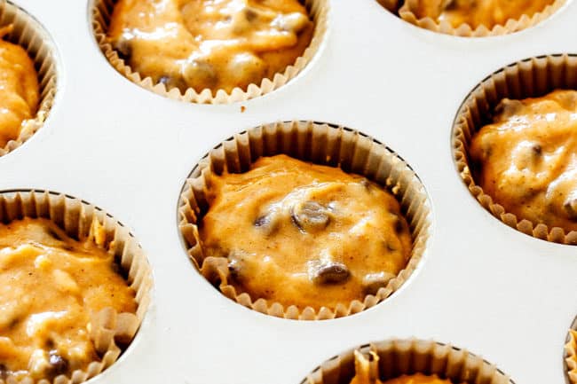 showing how to make fresh pumpkin muffins by adding pumpkin butter to muffin tins