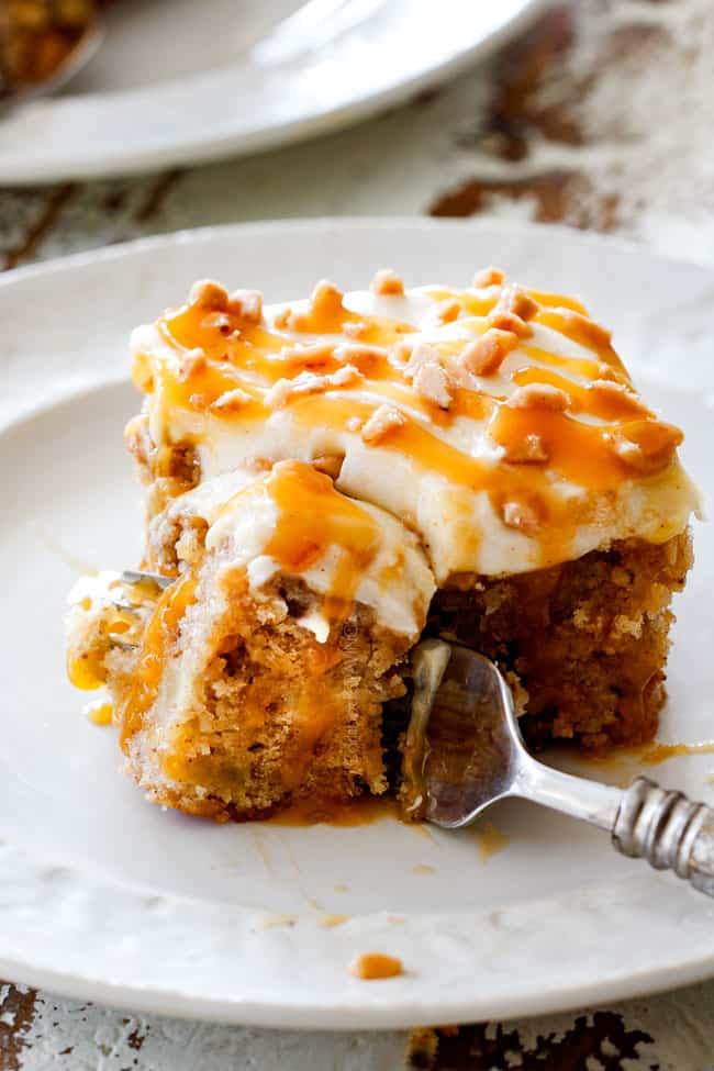 taking a bite out of apple poke cake recipe with a fork
