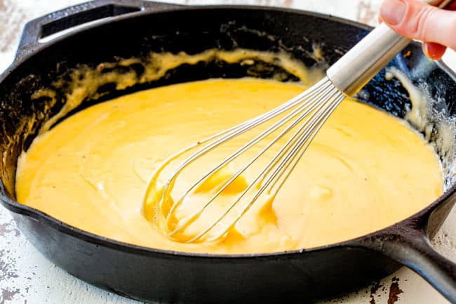 stirring cheese in a skillet to melt for Queso Fundido