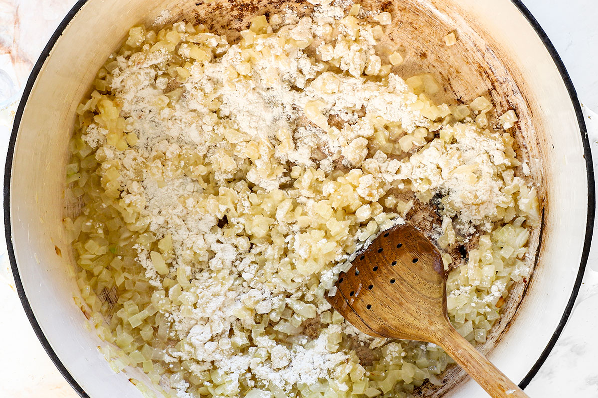 showing how to make broccoli cheese soup by adding flour and cooking to make a roux