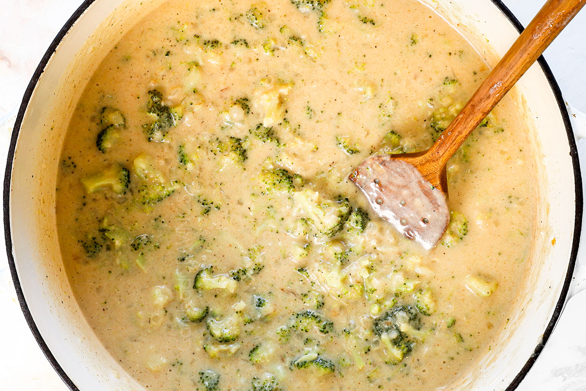 showing how to make broccoli cheese soup by simmering the soup until the broccoli s tender