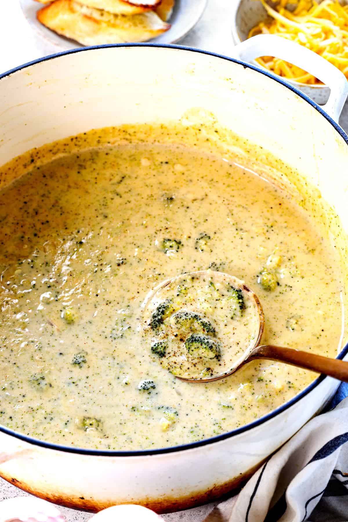 showing how to make broccoli cheese soup by stirring in additional milk after simmering