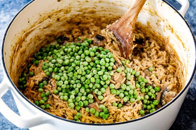 showing how to cook orzo pasta by adding peas to cooked orzo