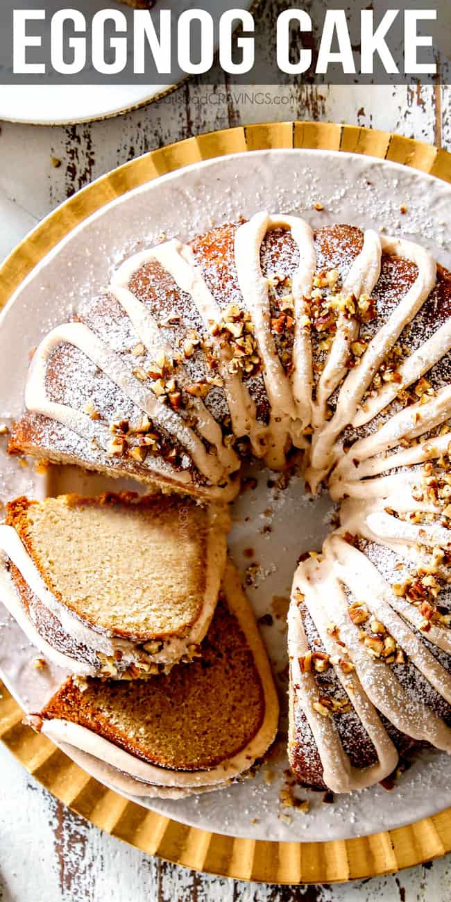 top view of southern Eggnog Cake on a white and gold platter with two slices cut and laying on their sides