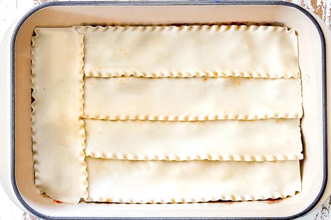 showing how to layer lasagna with a layer of lasagna noodles