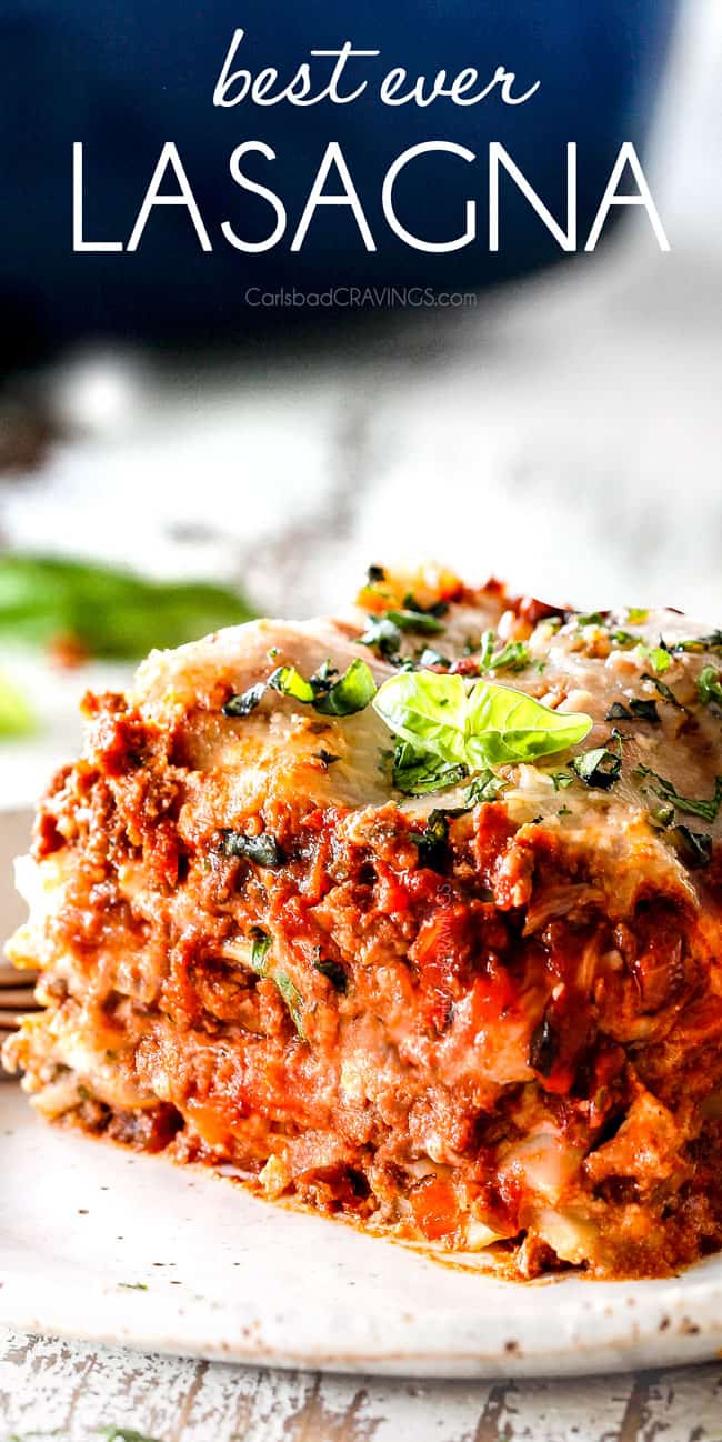 a slice of traditional lasagna with layers of ricotta, noodles, meat sauce, mozzarella, Parmesan with fresh parsley garnish on a white plate