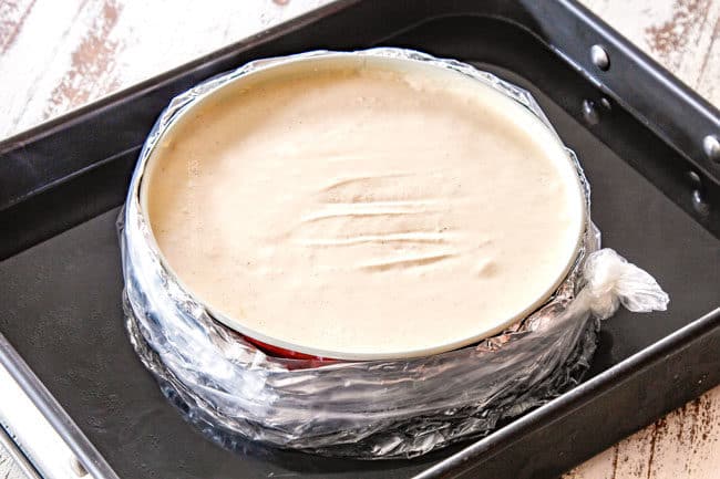 showing how to make Pecan pie cheesecake by placing it tin a water batth