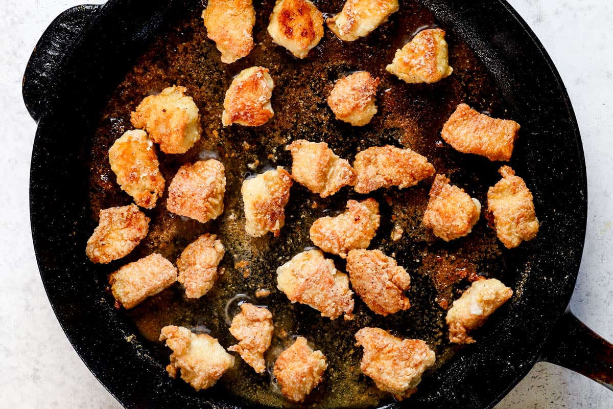 showing how to make sweet and sour chicken by browning the chicken in a skillet