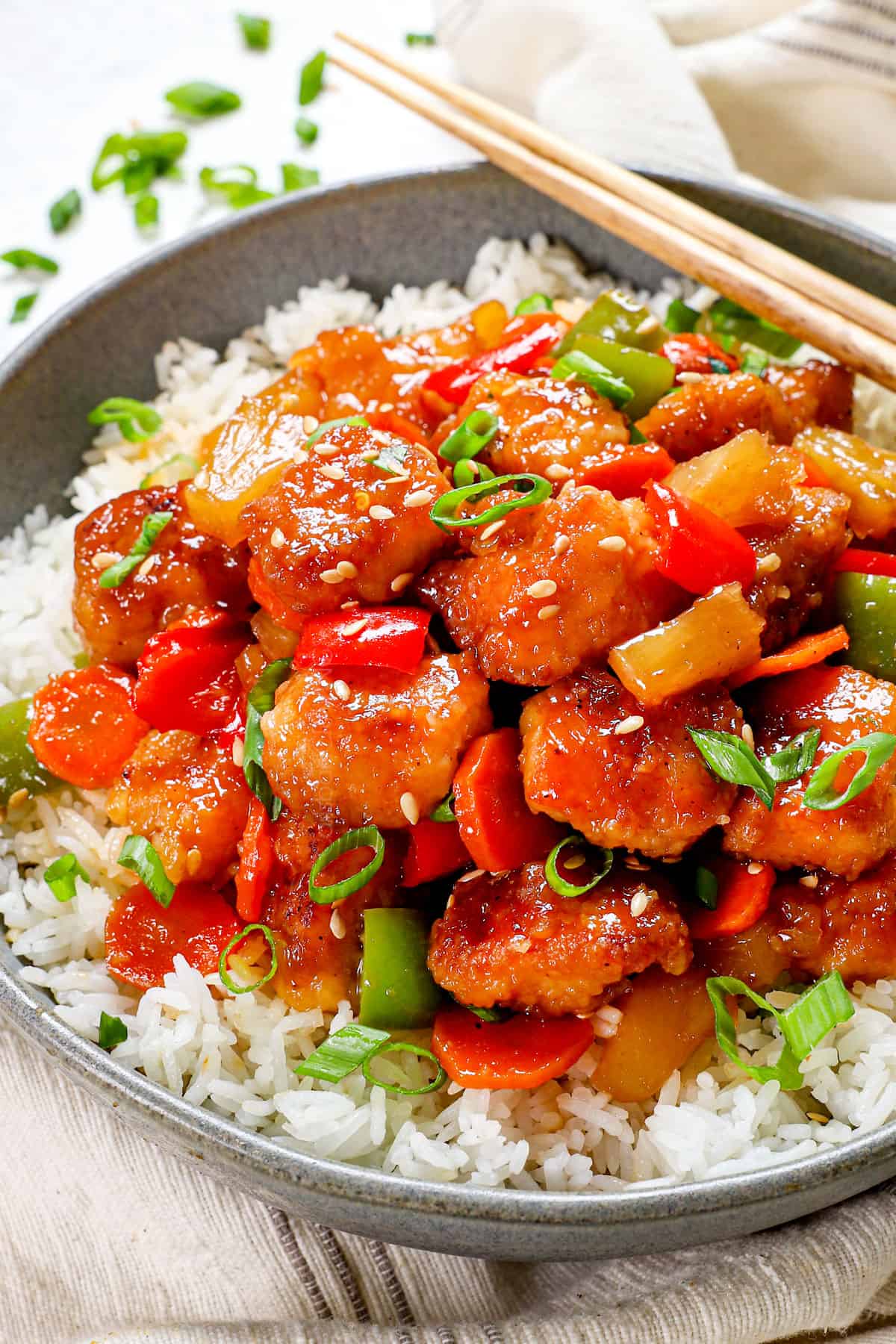 a bowl of sweet and sour chicken recipe with breaded chicken, pineapple, carrots and bell peppers