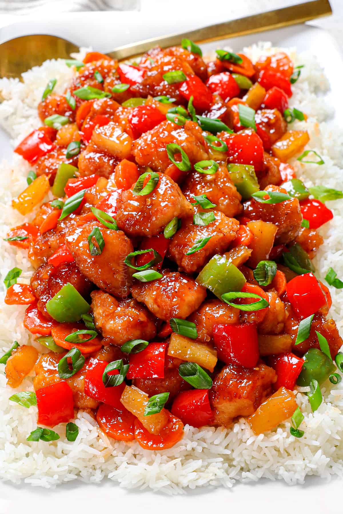 a platter of baked sweet and sour chicken showing the texture and thickened sauce