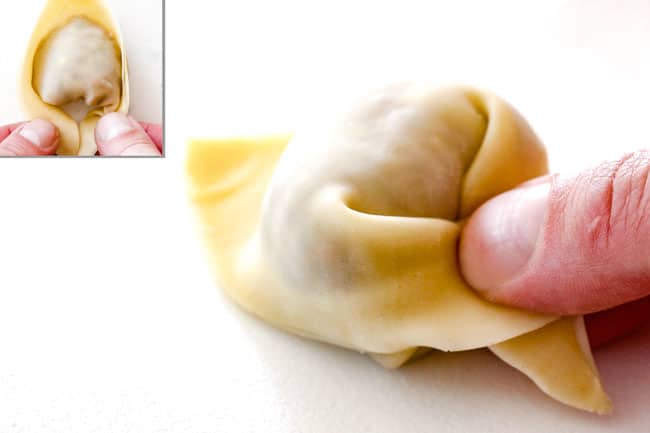 showing how to wrap wontons for wonton soup by crossing edges of wontons then pinching them to seal together.