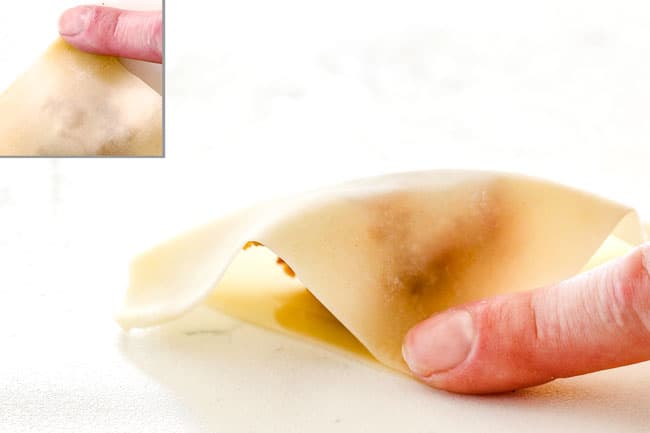 showing how to wrap wontons for wonton soup by bringing 2 opposite corners of the wonton together (2 dry, 2 wet) to form a triangle and enclose the filling, pinching edges of the wrapper together to firmly a seal, pressing out any air.