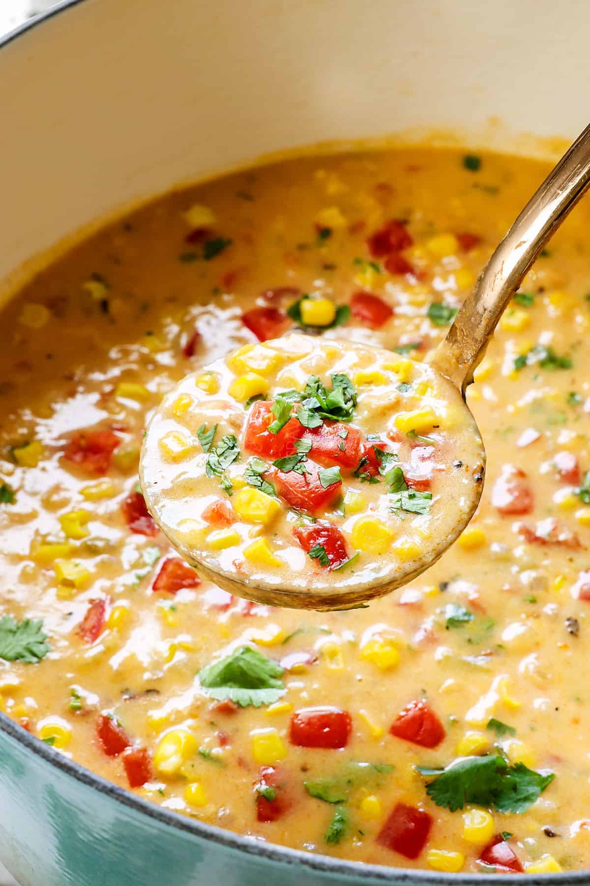 a ladle of chicken corn chowder recipe showing how creamy it is