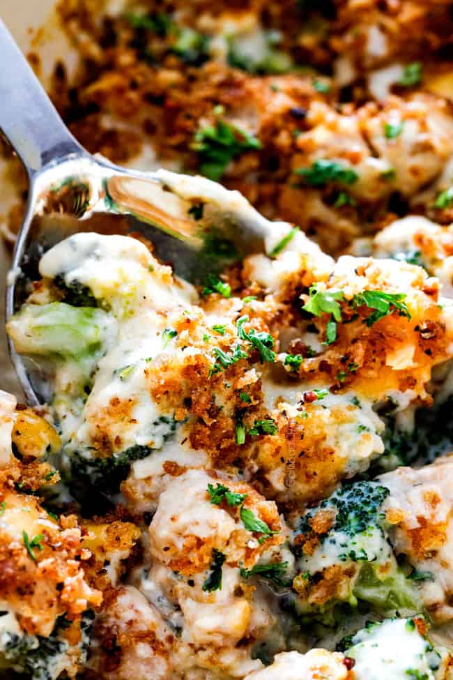 an up close serving spoon of chicken divan casserole with chicken and broccoli