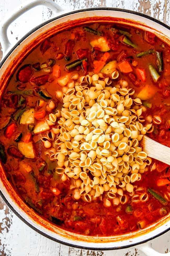 showing how to make best Minestrone Soup Recipe by adding pasta to soup