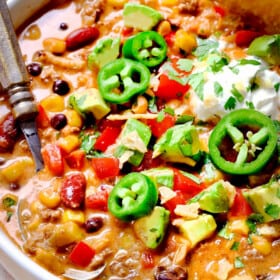 up close of a a bowl of easy taco soup piled with toppings