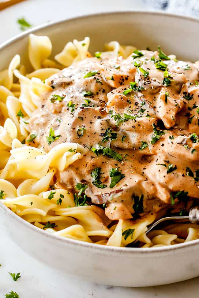 up close of juicy Chicken Stroganoff in a white bowl