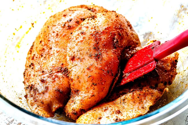 showing how to make Honey Mustard Chicken by rubbing chicken in spices