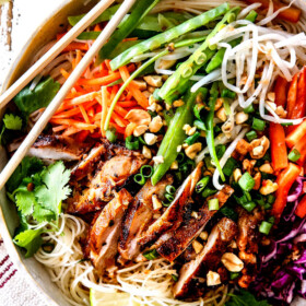 top up close view of Vietnamese noodle with rice noodles, lemongrass chicken, shredded carrots, julienned carrots, bean sprouts and snow peas
