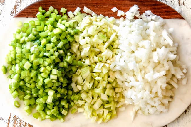 showing how to make cauliflower soup by chopping onions, celery and fennel