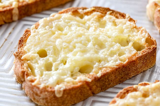 showing how to make French Onion Soup by melting Gruyere cheese on a slice of bread
