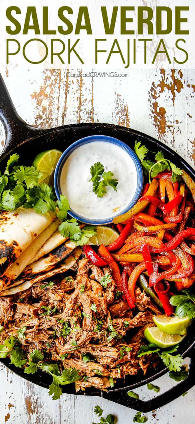 top view of pork fajitas in a skillet with salsa verde pork, bell peppers, onions, limes, cilantro and tortillas