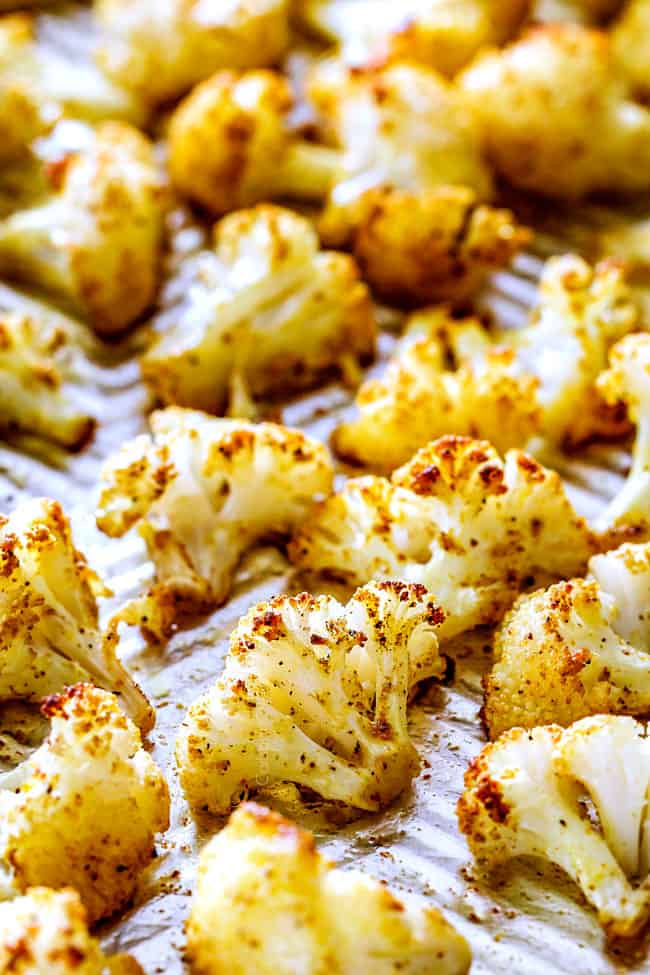 rows of cumin roasted cauliflower on a baking sheet with crispy ends