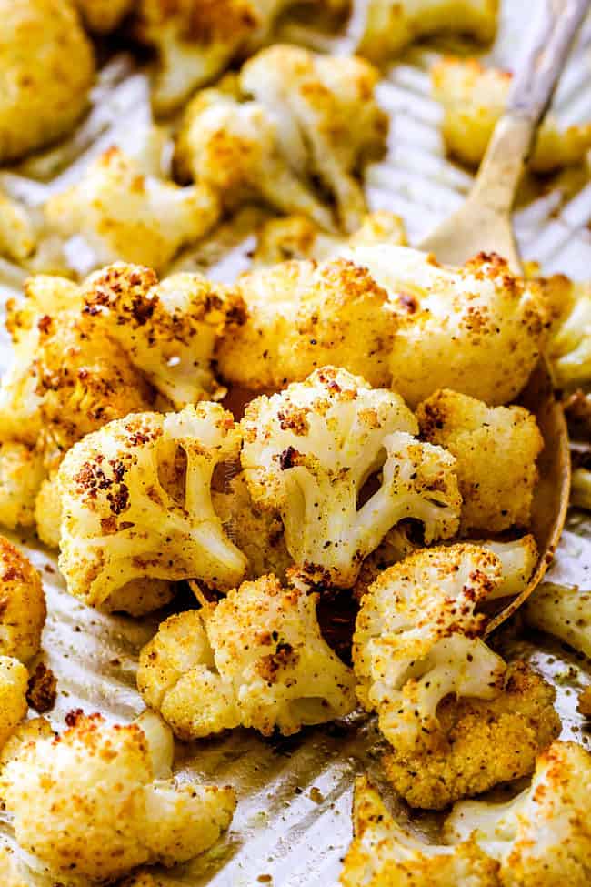 showing how to make rice bowl recipe with a spoonful of curry roasted cauliflower
