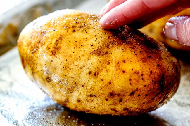 showing how to make twice baked potatoes by rubbing with salt and pepper