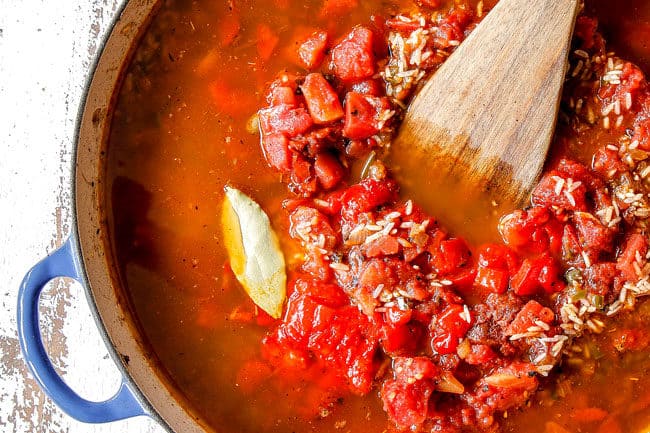 showing how to make Arroz con Pollo by adding tomato paste, diced tomatoes, bay leaves to chicken and rice