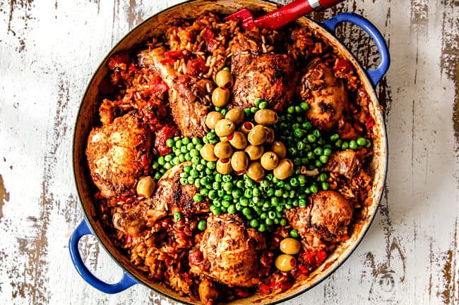 showing how to make Arroz con Pollo by adding peas and olives to baked chicken