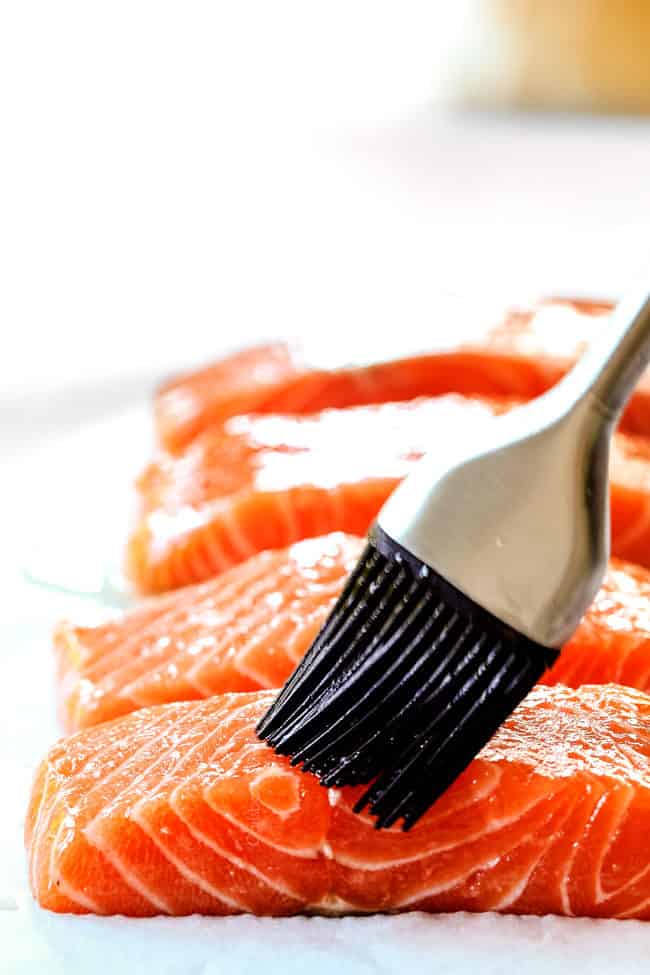 showing how to make blackened salmon by rubbing it with olive oil